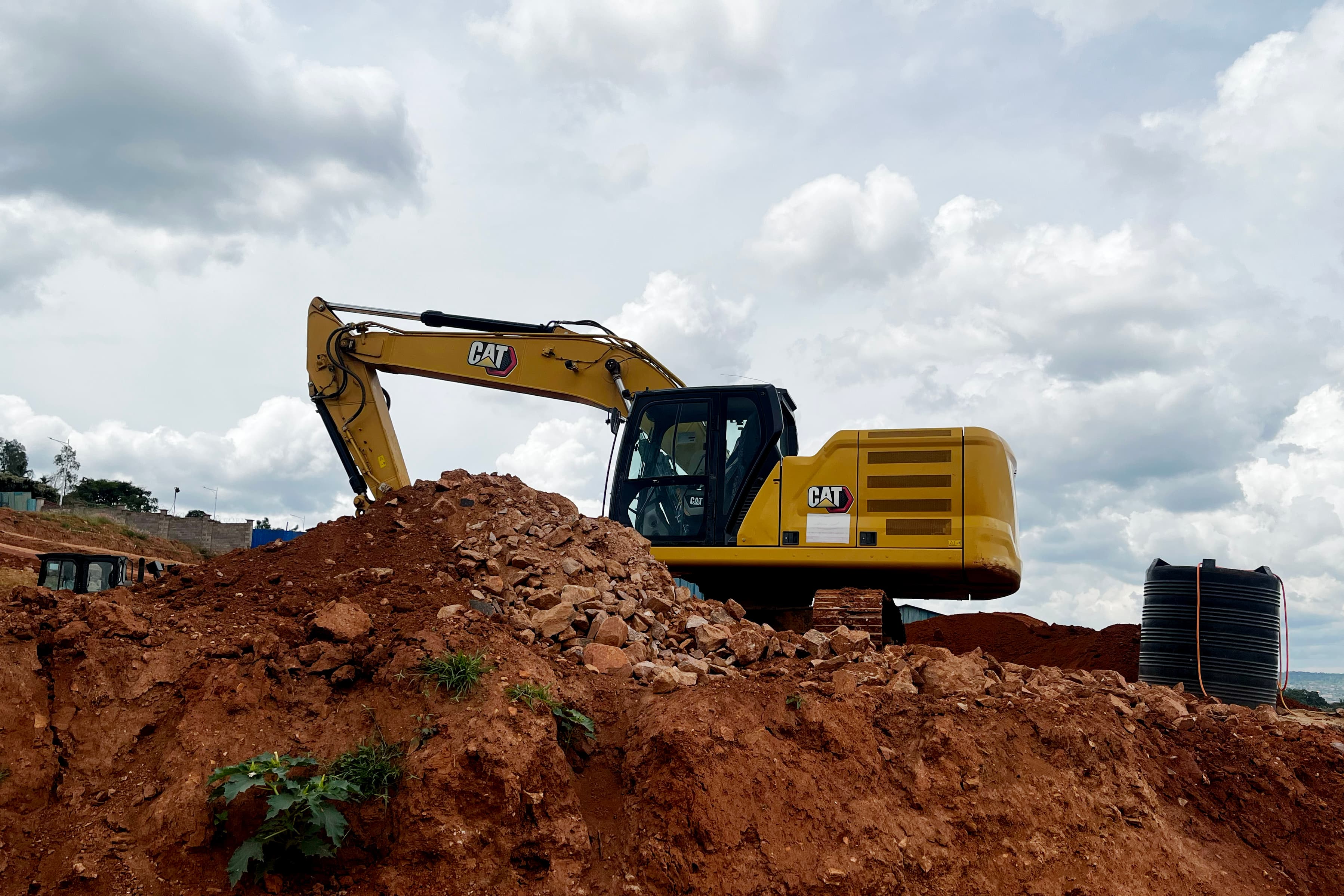Excavator working on a ridge against the sky