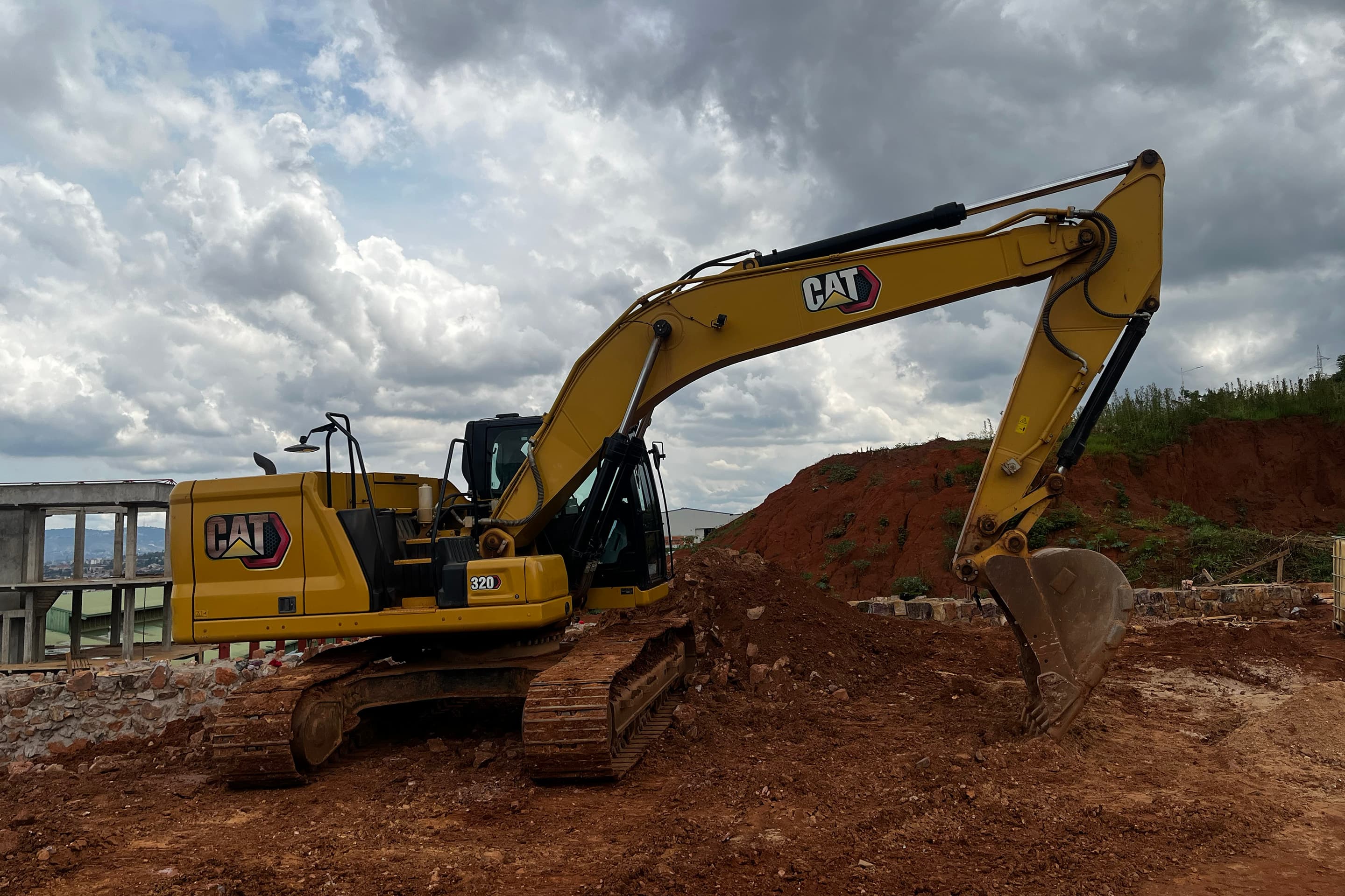KAYOS excavator working a graded earthworks mound